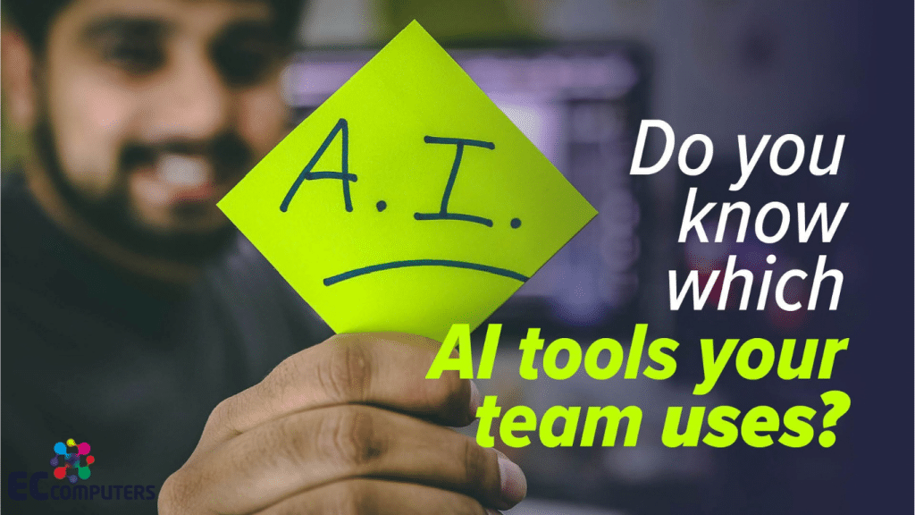 A smiling man holding up a bright yellow sticky note marked "A.I." with a downturned mouth drawn underneath, next to the headline "Do you know which AI tools your team uses?" and the EC Computers logo.